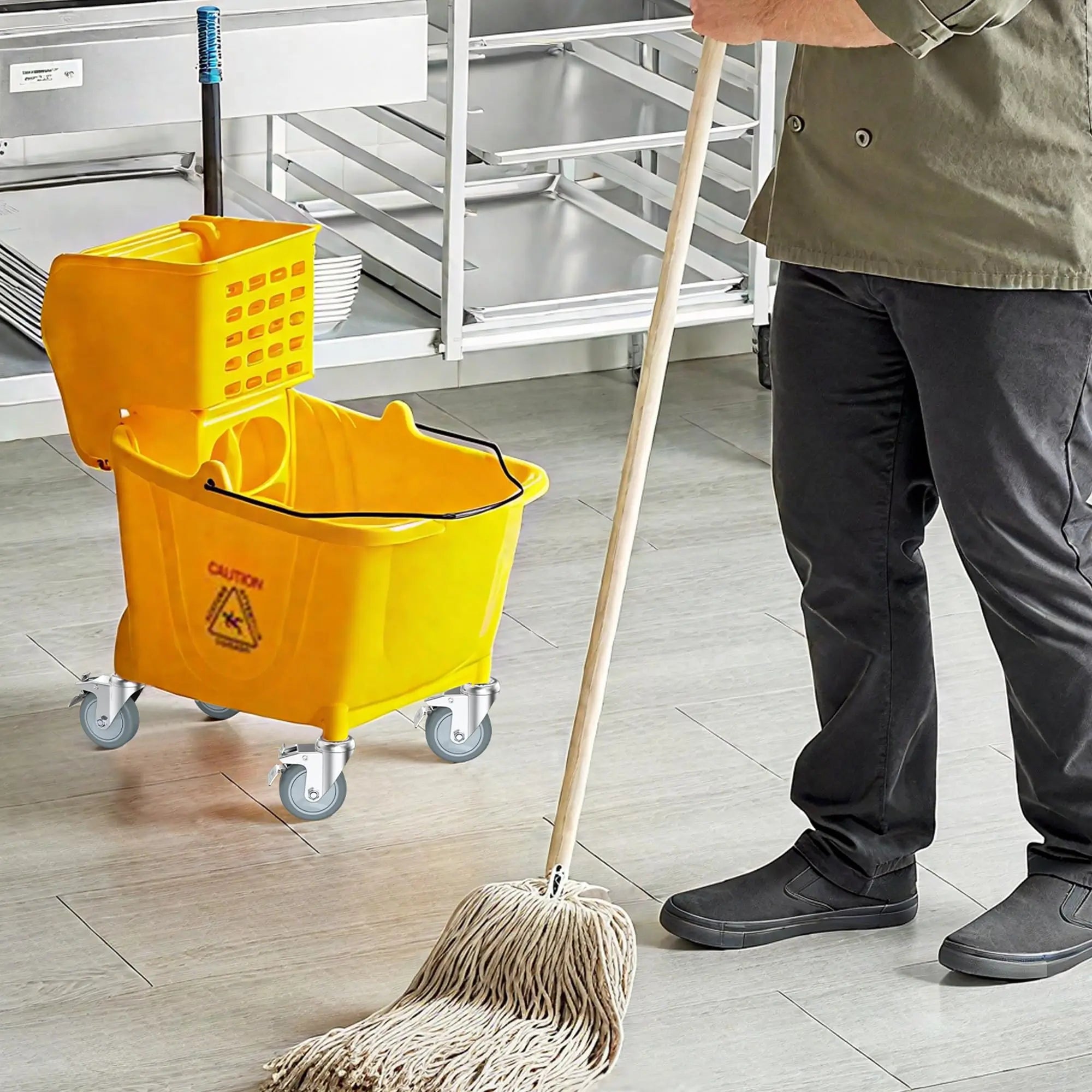 Cleaning a floor with a mop and yellow cleaning cart with 3" grip ring stem caster wheel with total lock brake in a kitchen setting