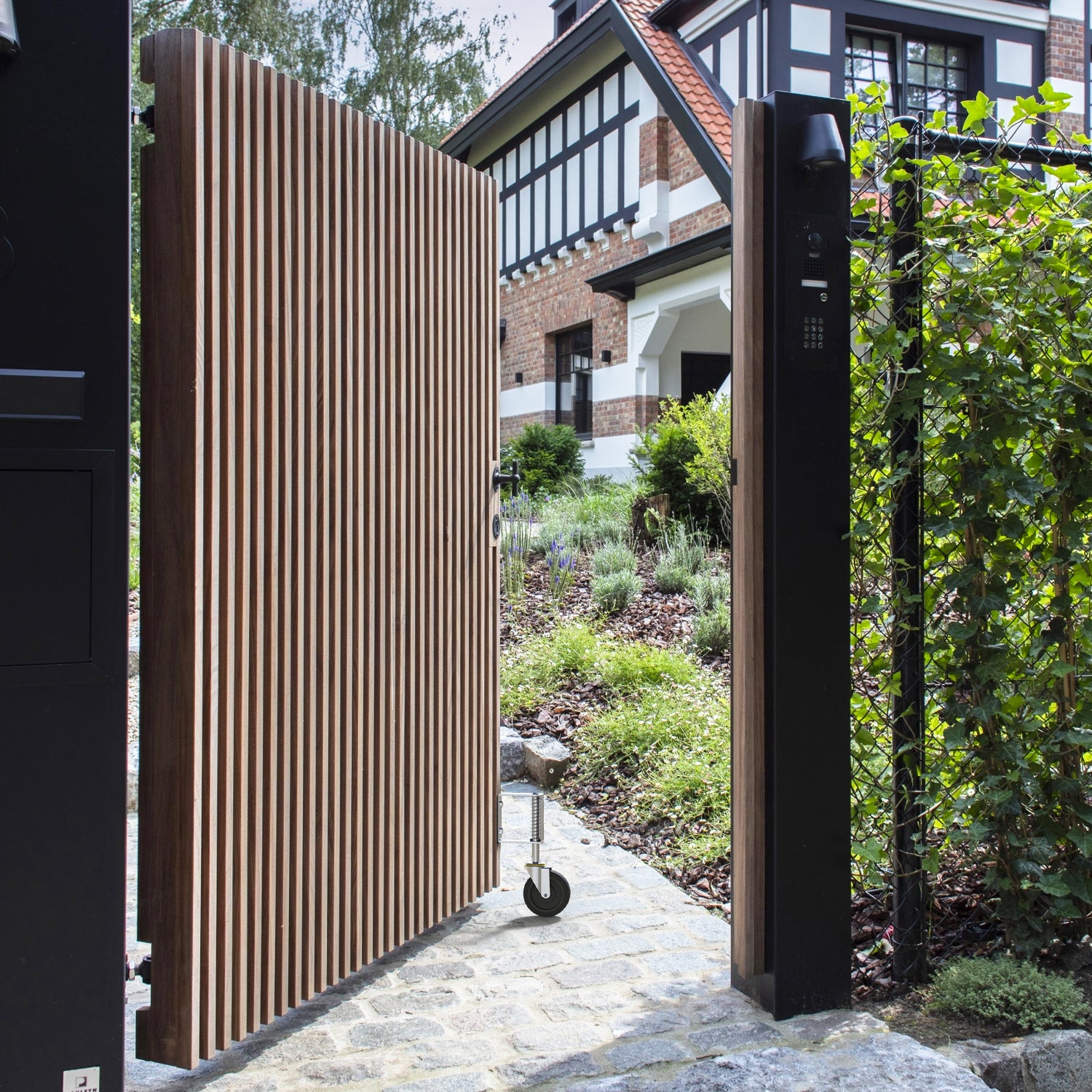 Single-sided wooden gate with Holkie 4 inch spring loaded gate wheel, opening to a garden path